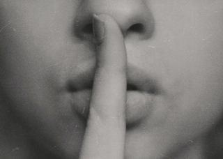 czarno-białe zdjęcie kobiety trzymającej palec na ustach